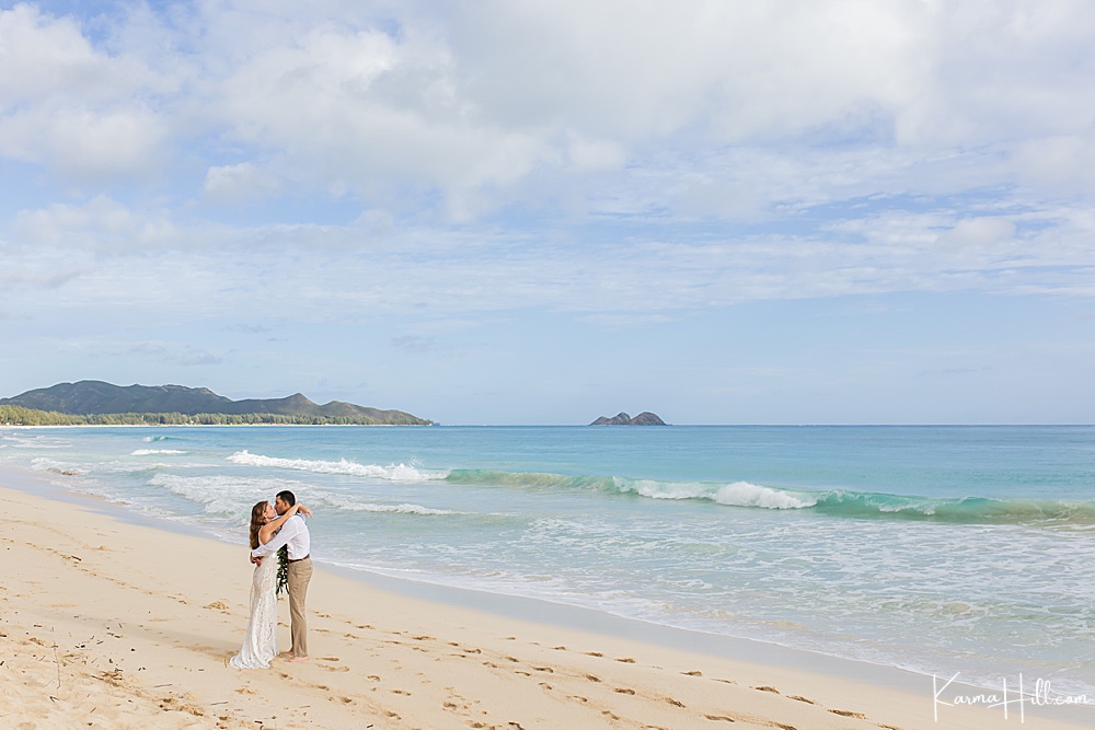 bride and groom kissing on oahu beach 