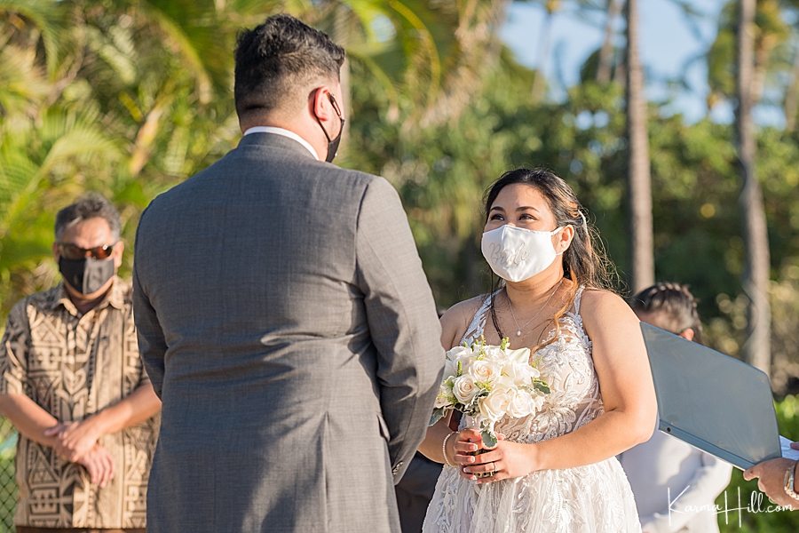 bride and groom in face masks in hawaii 