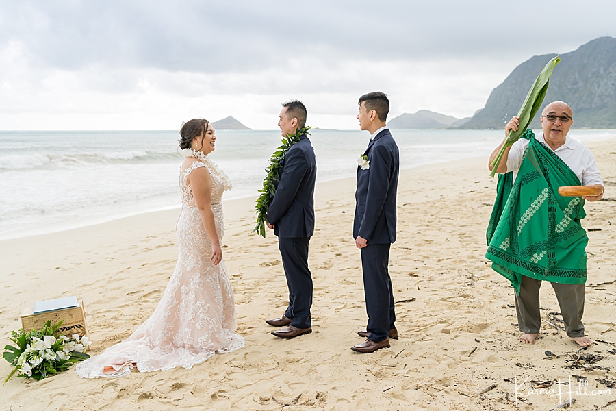 hawaiian minister performs ti leaf blessing during wedding in oahu 