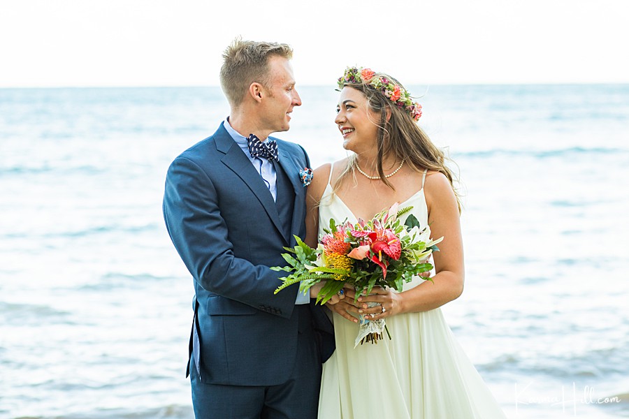 couple get married on oahu with the groom in a polka dot bowtie and bride in a simple white gown with a flower crown 