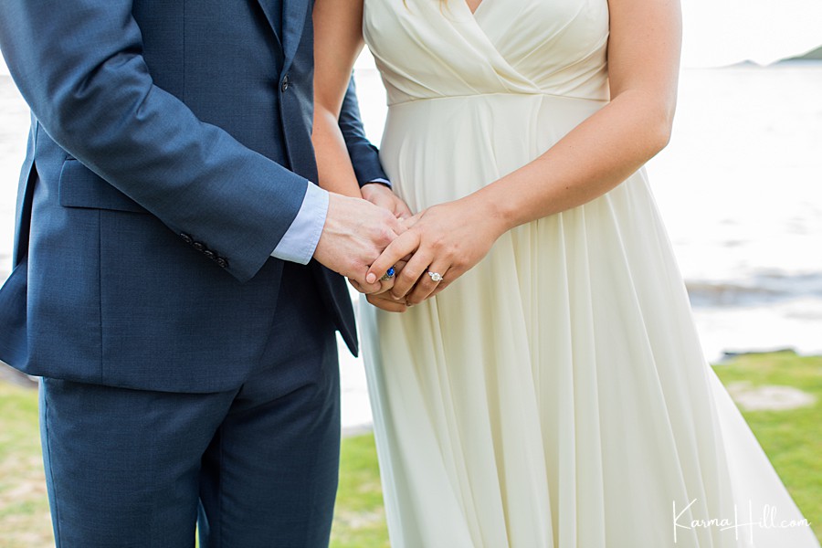 close up of bride and groom's hands during their hawaii wedding 