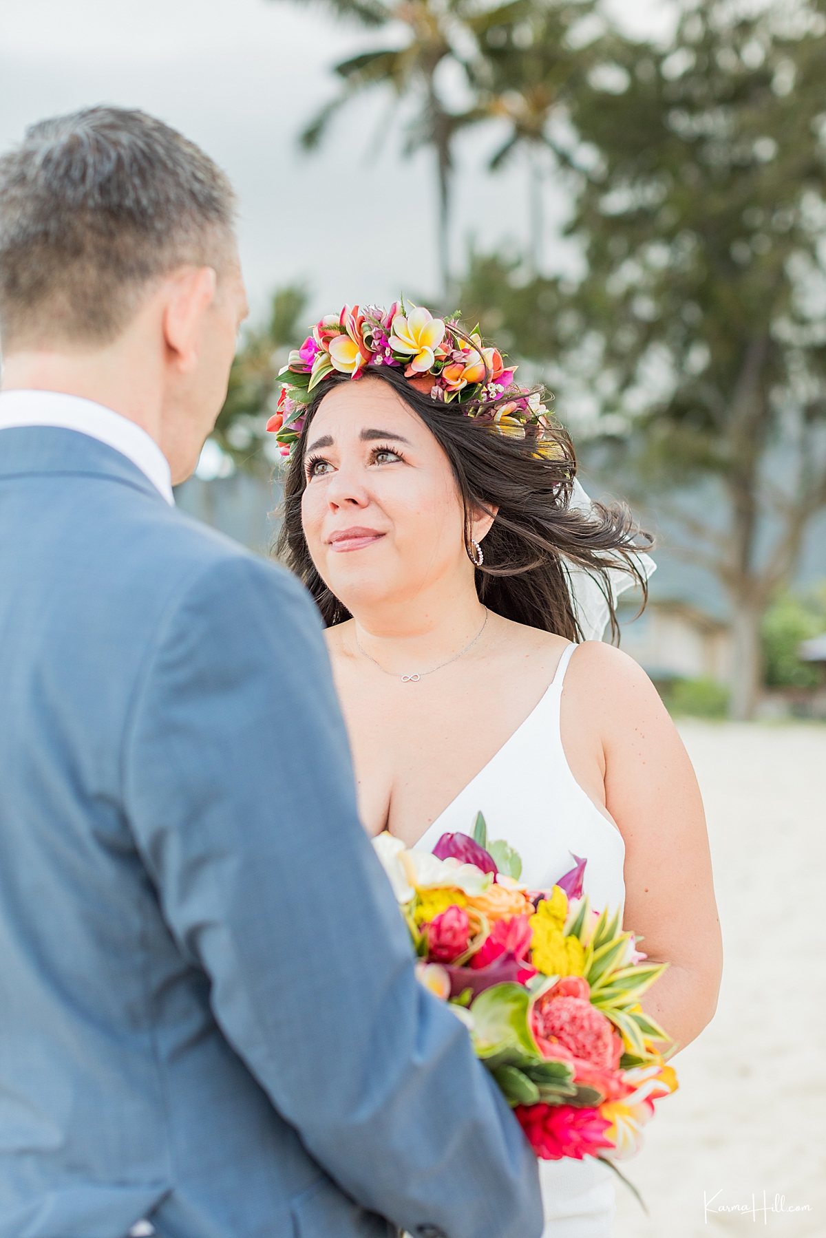 bride looks lovingly into the eyes of her groom during beach wedding in hawaii 