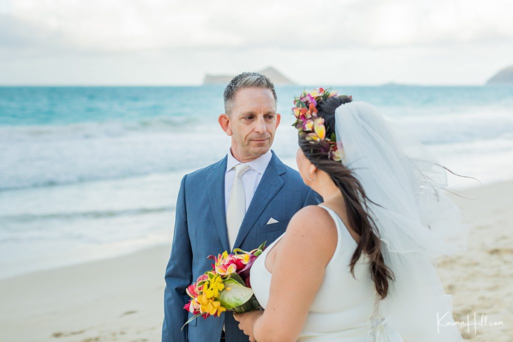 groom gazes into bride's eyes during hawaii elopement 