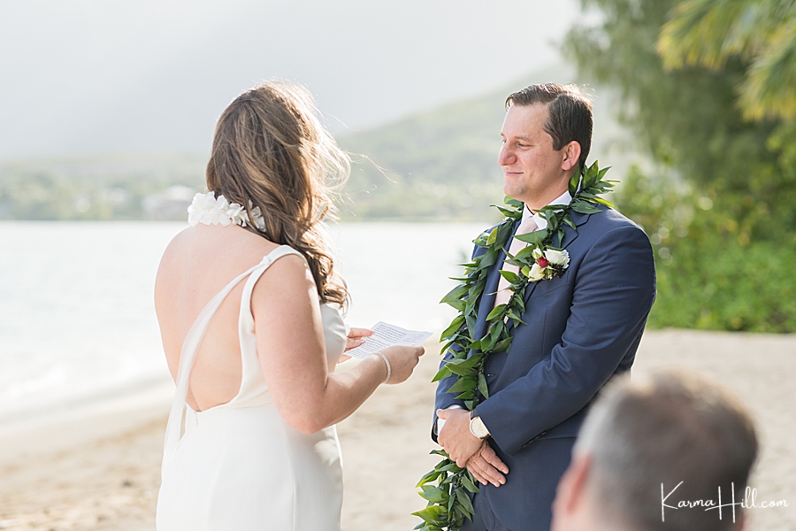 bride exchanging vows with groom at hawaii wedding