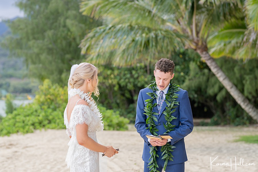 groom telling vows to bride at venue wedding in hawaii