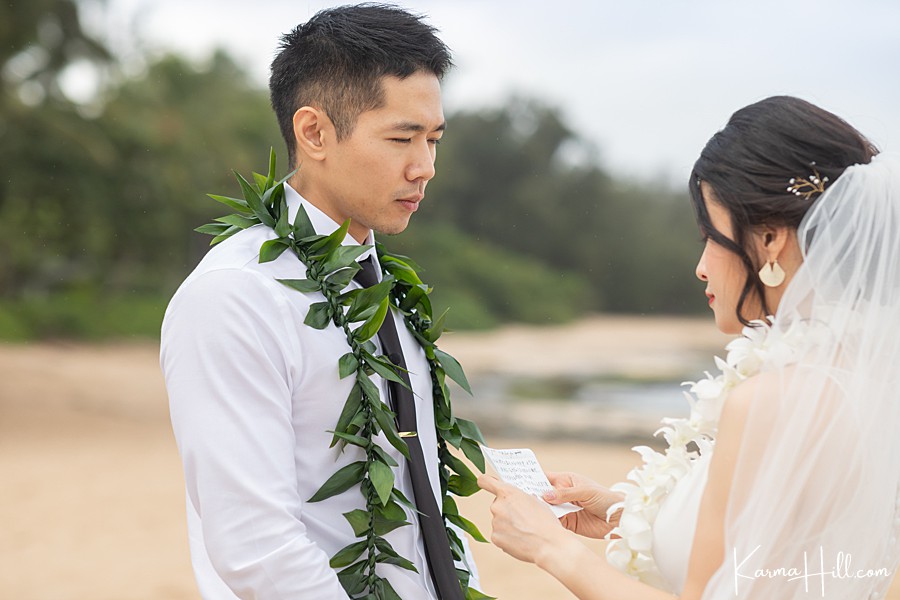 bride telling groom vows at hawaii wedding