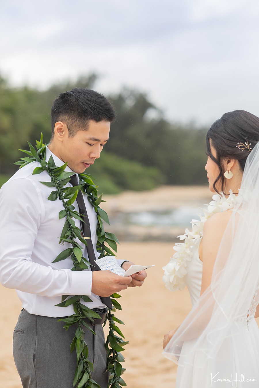 groom telling bride vows at hawaii wedding