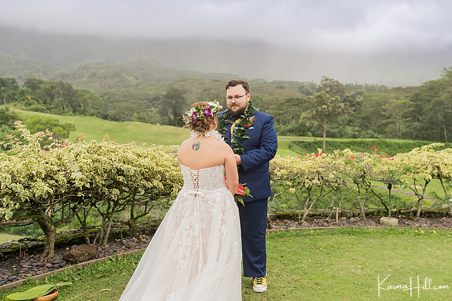 bride and groom exchanging vows at oahu wedding