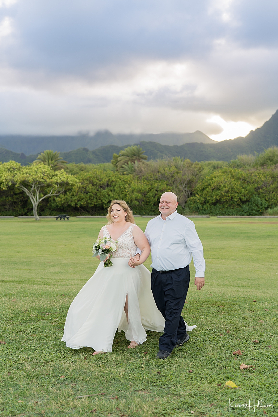 bride walking down the aisle with father at oahu wedding