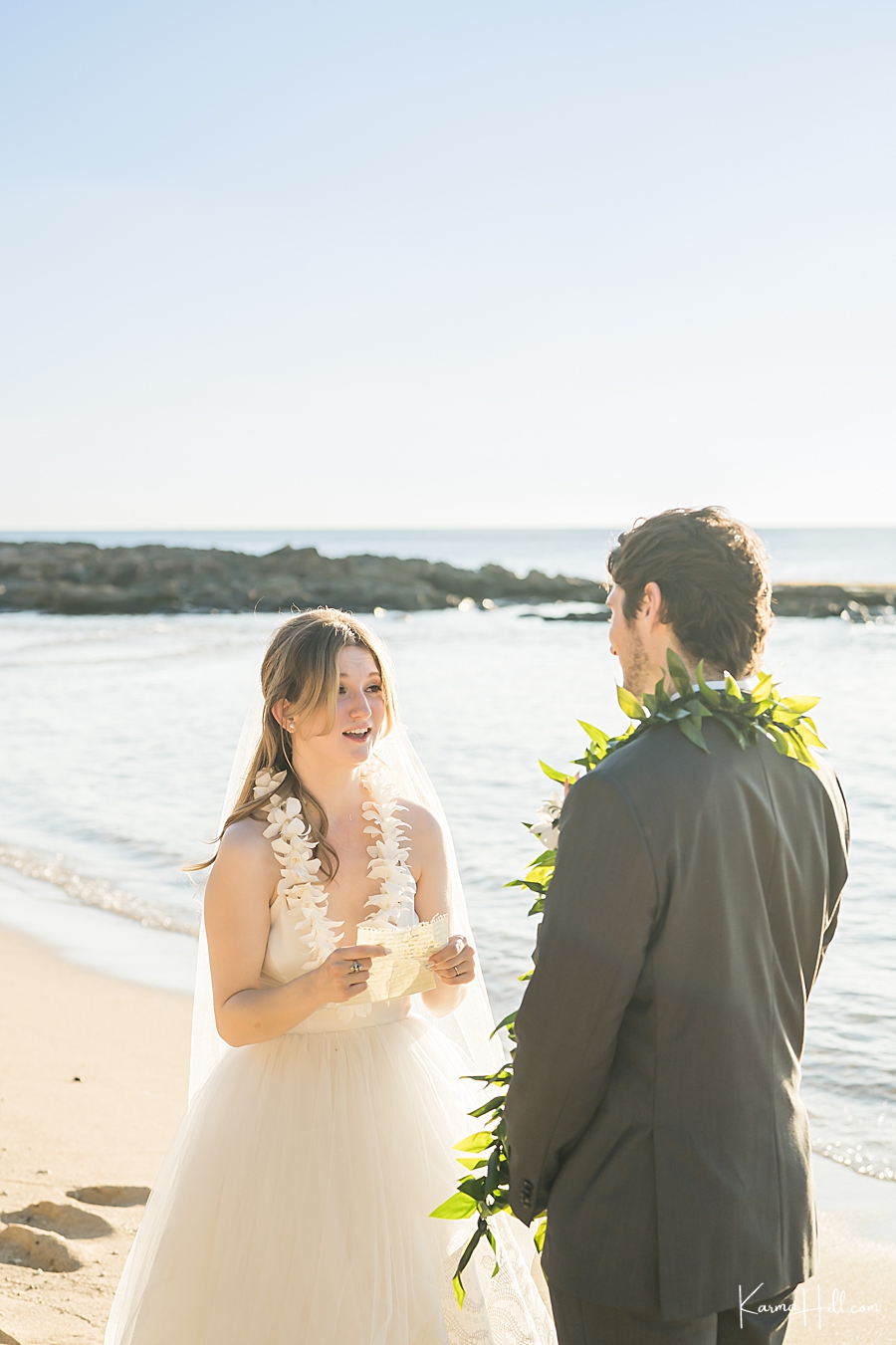 bride exchanging vows with groom at hawaii wedding