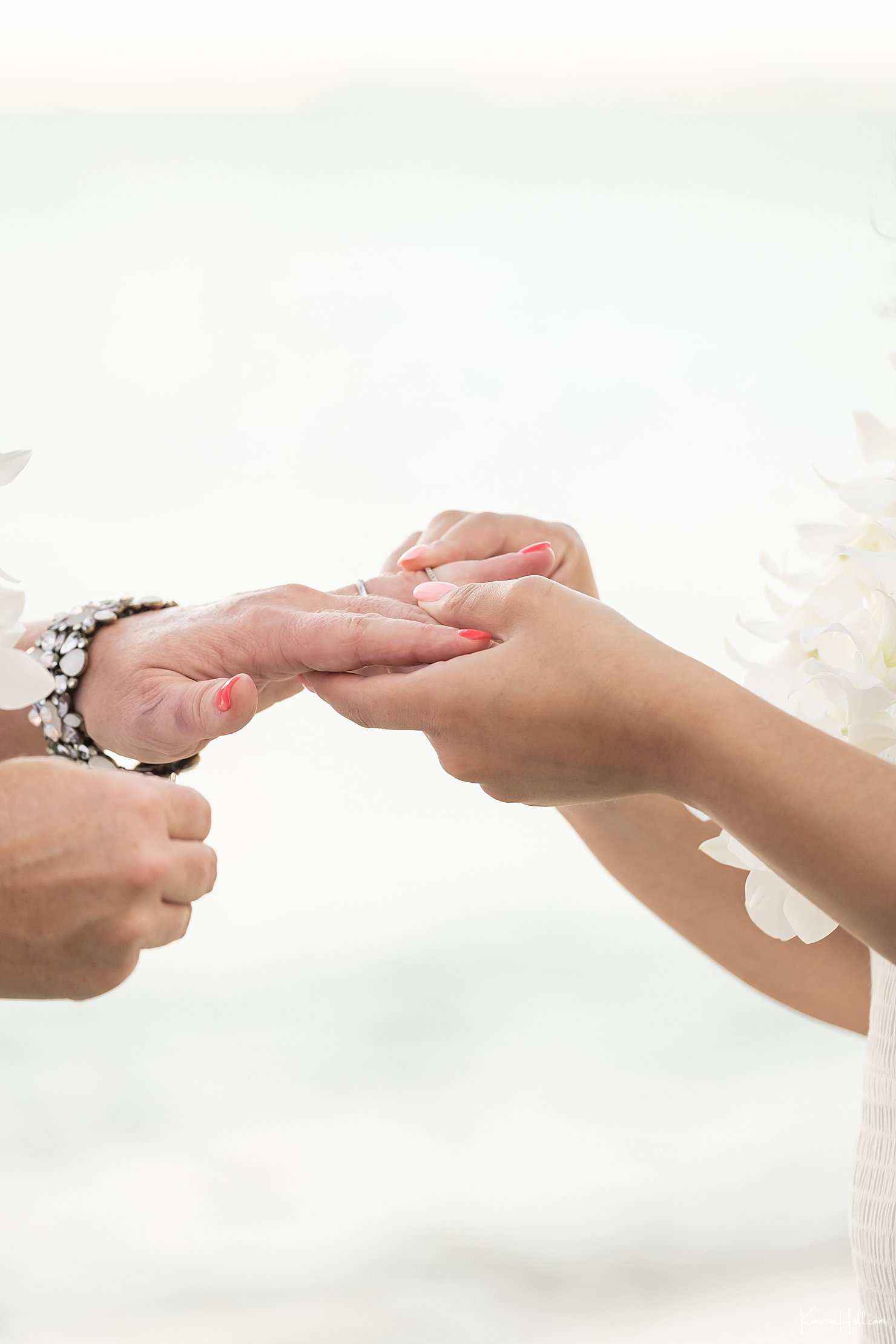 bride exchanging ring with bride at hawaii wedding