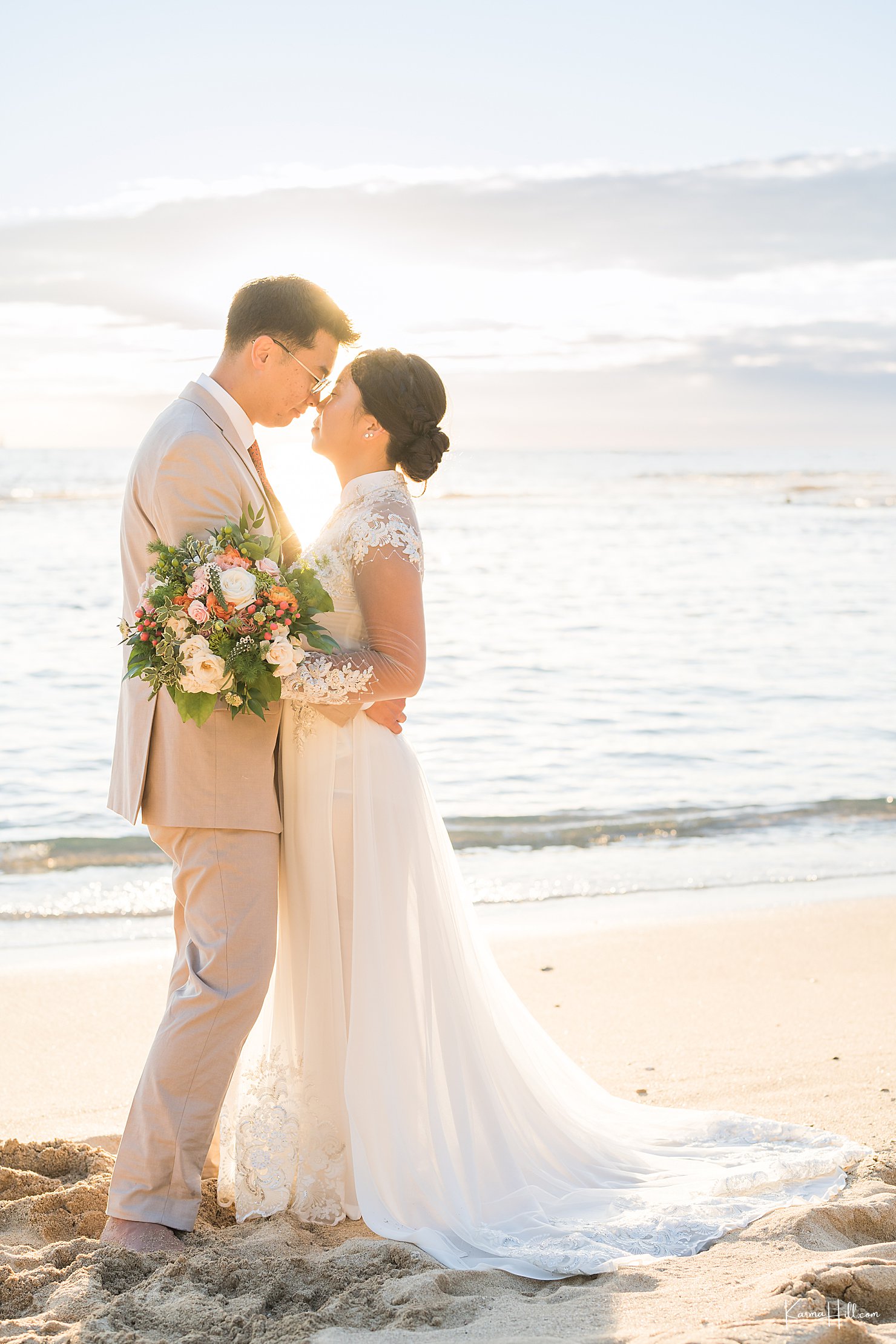 newlyweds on beach at sunset