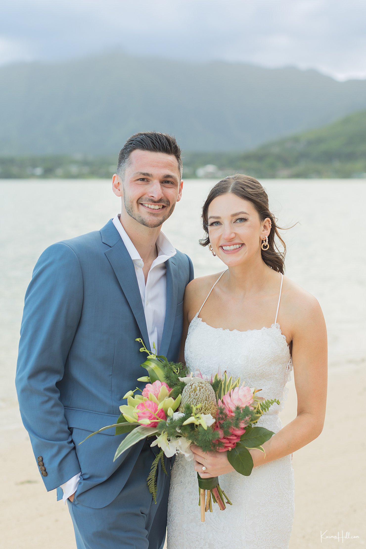 newlyweds on beach in oahu
